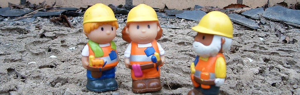 House builders surveying the building plot