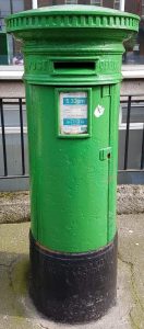 Emerald green Irish letterbox outside homes