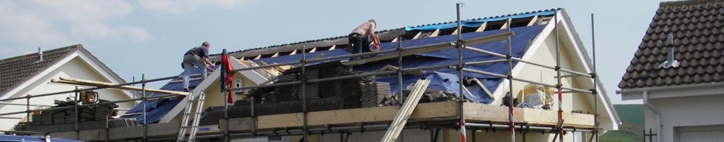 men working on house roof