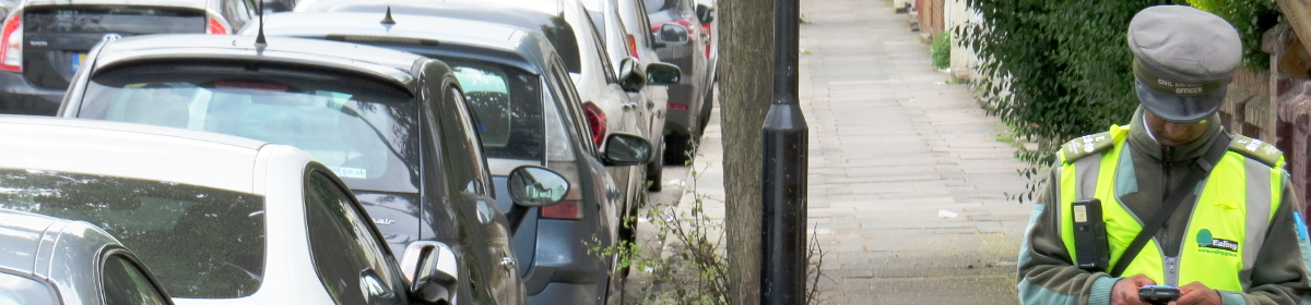 traffic warden logging vehicles outside homes in Ealing, London