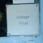 Rental cottage to let sign displayed in house window