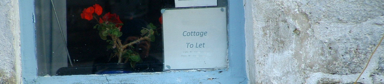 Cottage to let sign displayed in house window