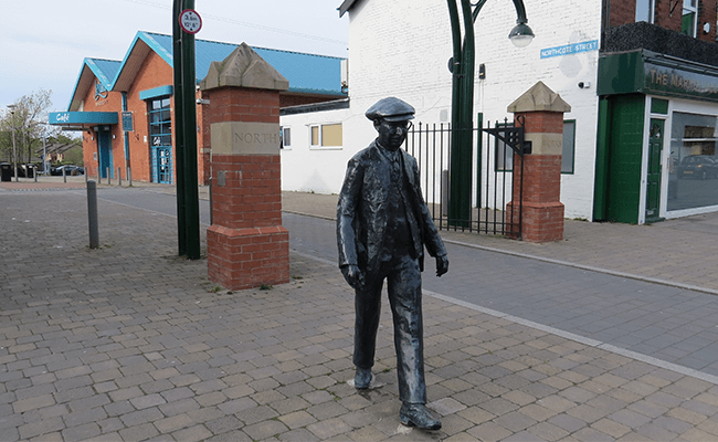 Statue of worker leaving the north entrance in Leyland